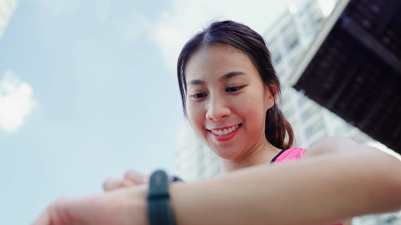 someone smiling checking a watch.